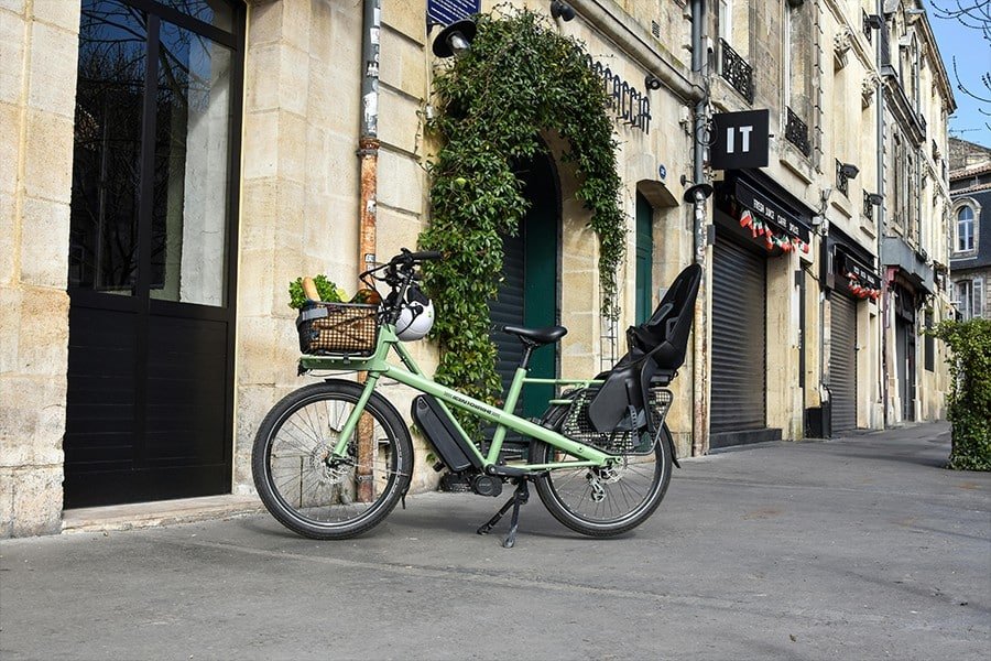 Green Long tail cargo bikes on the street, Photo by Jean Fourche from pexels .png