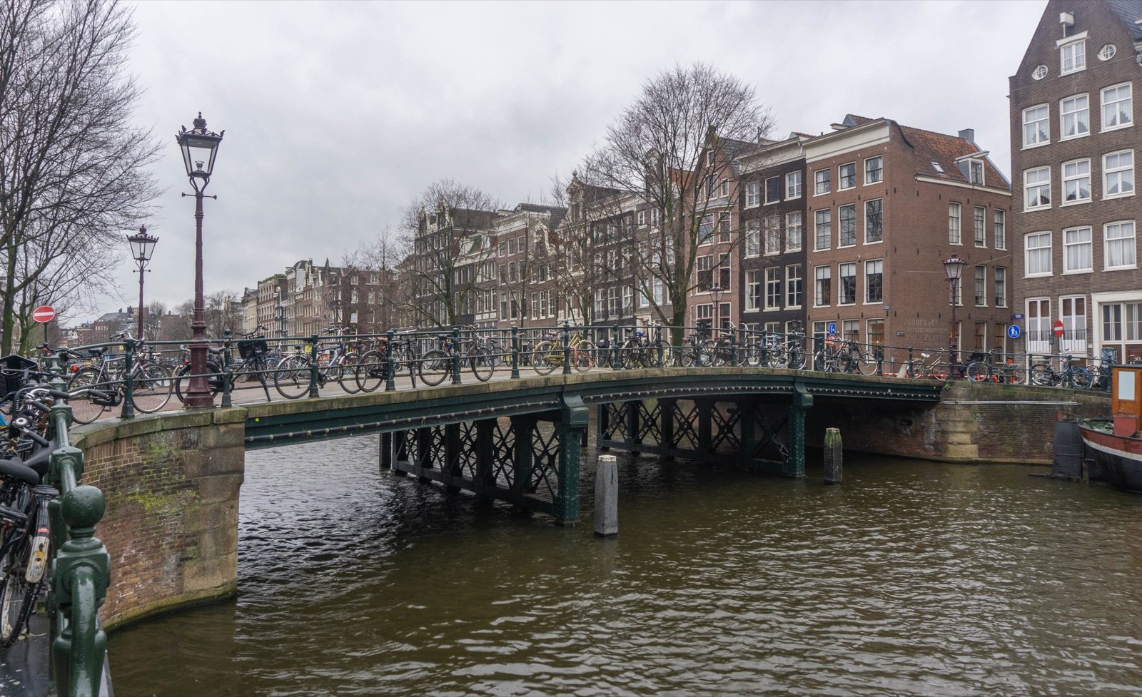Bicycles beside a canal bridge in Amsterdam