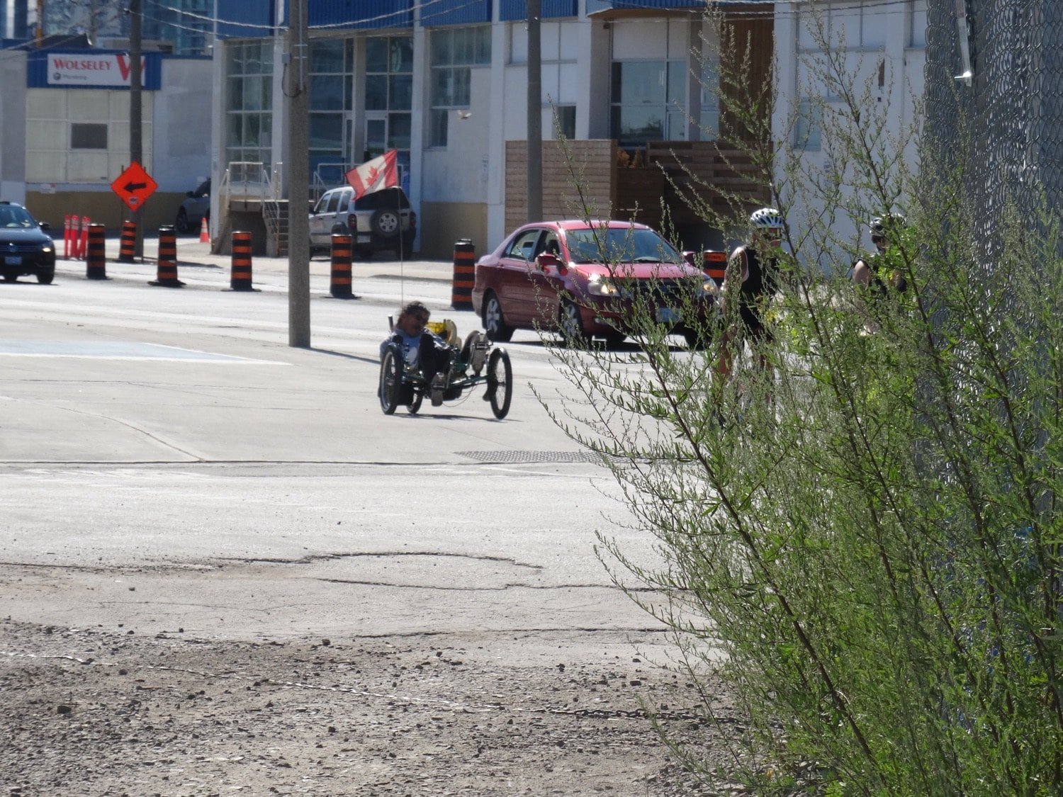 A recumbent tricycle riding along a quayside